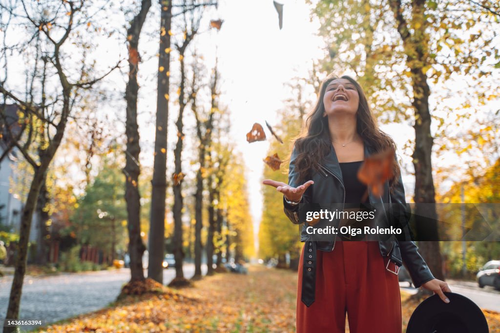 Catching Falling Enjoyment In Autumn Carefree Young Woman Catching Falling The Foliage ...