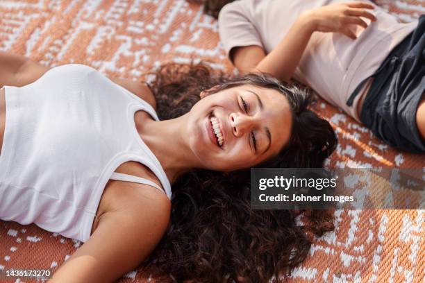 girl lying down on blanket - girl lying down stock pictures, royalty-free photos & images