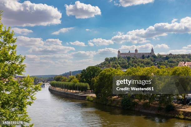 germany, bavaria, wurzburg, clouds over river main with marienberg fortress in background - würzburg stock pictures, royalty-free photos & images