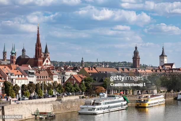 germany, bavaria, wurzburg, river main and surrounding old town buildings - würzburg foto e immagini stock