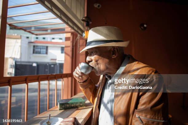 older man drinking coffee - cuban ethnicity stock pictures, royalty-free photos & images