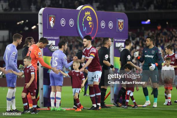 Players of both side's and Match Officials shake hands in front of the Stonewall Rainbow Laces campaign handshake board prior to the Premier League...