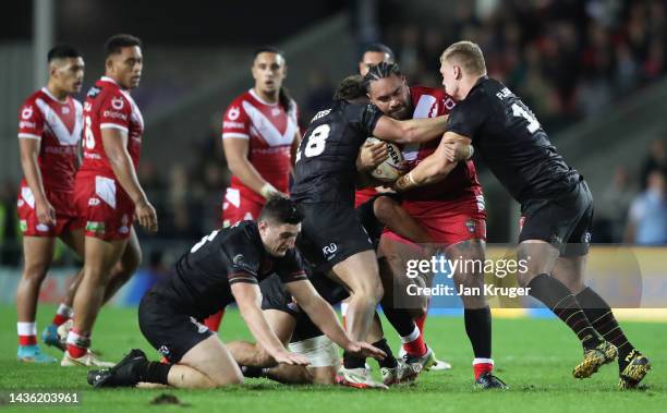 Konrad Hurrell of Tonga looks to break past Connor Davies of Wales during the Rugby League World Cup 2021 Pool D match between Tonga and Wales at...