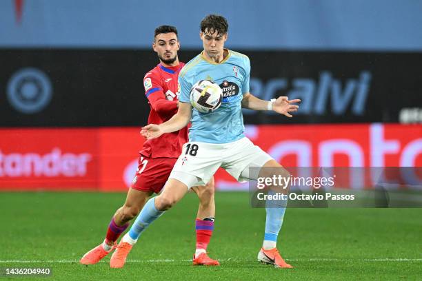 Jorgen Strand Larsen of Celta Vigo battles for possession with Juan Iglesias of Getafe CF during the LaLiga Santander match between RC Celta and...