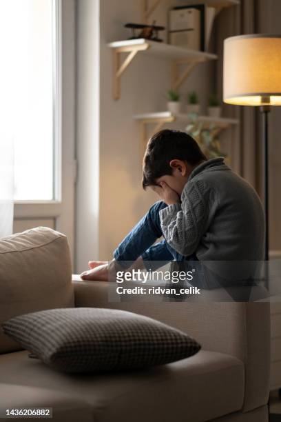 lonely sad boy at home - child abuse prevention stock pictures, royalty-free photos & images
