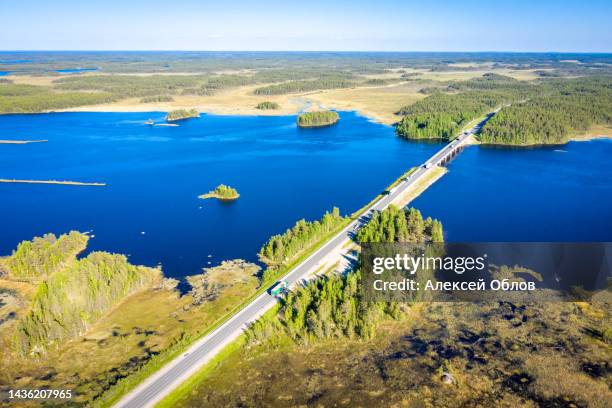 aerial view on karelian lake lindozero and road bridge. lake in karelia in summer. blue lake and green forest top view - lake ladoga stock pictures, royalty-free photos & images