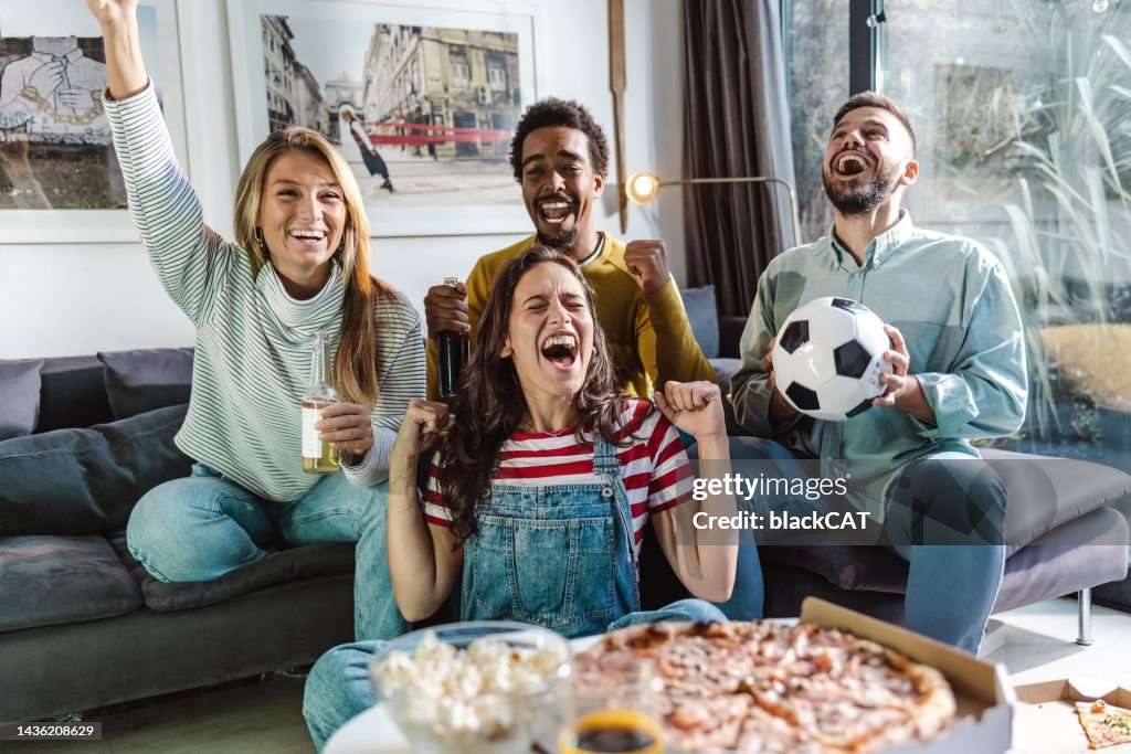 Amigos em casa assistindo jogo de esportes