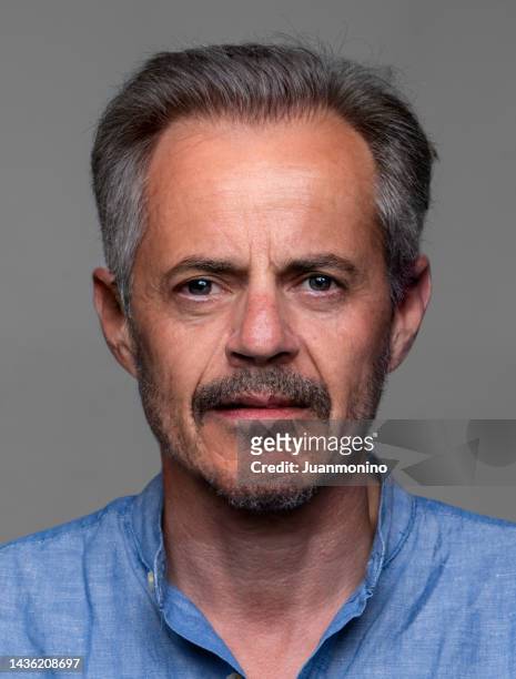 serious man front mugshot on gray background - mug shot stock pictures, royalty-free photos & images