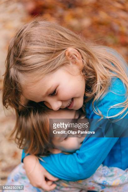 two cute children hug and smile. - world kindness day stock pictures, royalty-free photos & images