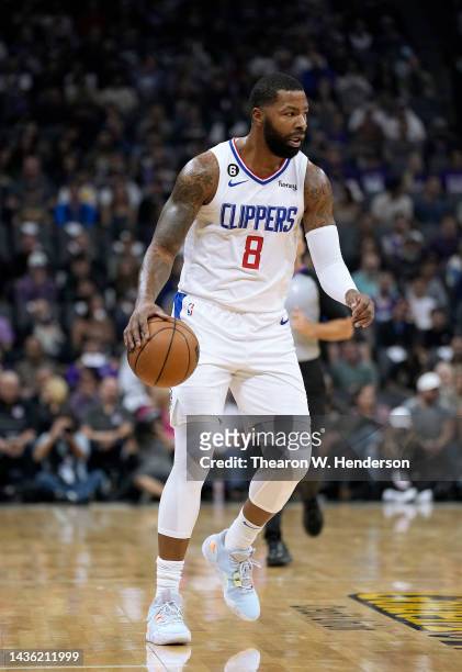 Marcus Morris Sr. #8 of the LA Clippers dribbles the ball up court against the Sacramento Kings in the first quarter of an NBA basketball game at...