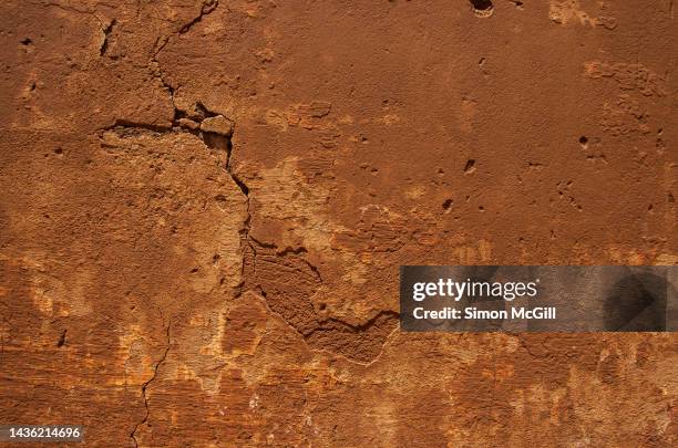 crumbling ancient adobe stucco wall - adobe texture stock pictures, royalty-free photos & images