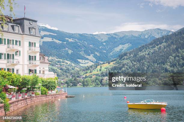 lake zell surrounded by picturesque view of european alps - zell am see stock pictures, royalty-free photos & images