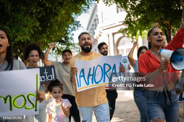 protesters holding signs during on a demonstration outdoors - childrens justice campaign event stock pictures, royalty-free photos & images