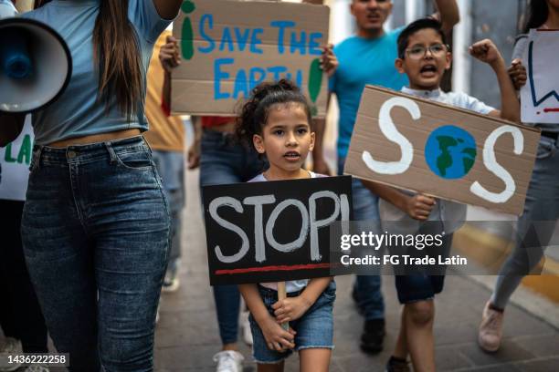 children holding signs about the environment at a protest - defend your rights stock pictures, royalty-free photos & images