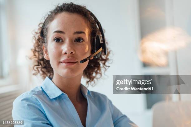 young customer service representative wearing headset - operadora imagens e fotografias de stock