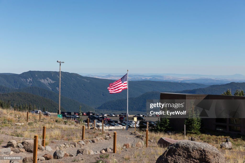 American flag flying over the parking lot at the base of Mt. Hood and Timberline Lodge