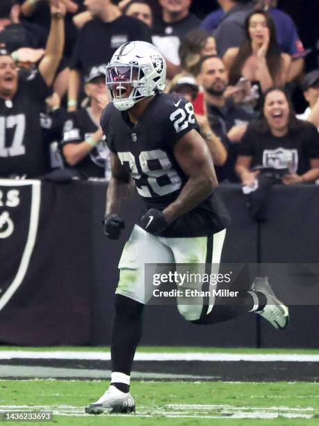 Running back Josh Jacobs of the Las Vegas Raiders celebrates his 15-yard touchdown run against the Houston Texans in the fourth quarter of their game...