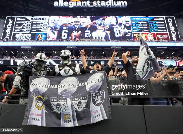 Las Vegas Raiders fans react after safety Duron Harmon of the Raiders returned an interception 73 yards for a touchdown against the Houston Texans in...