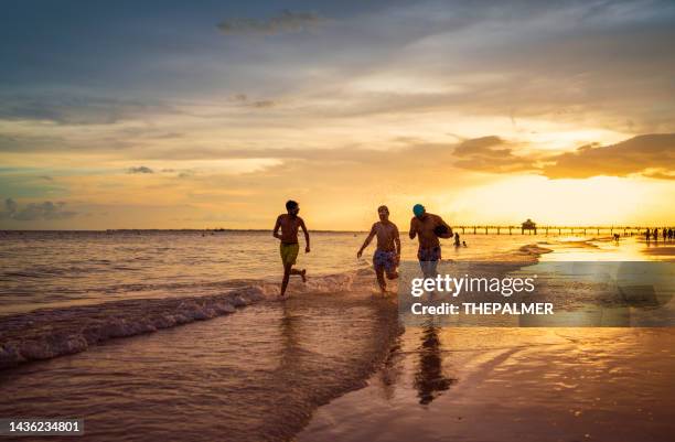 running on the beach in florida - fort myers bildbanksfoton och bilder