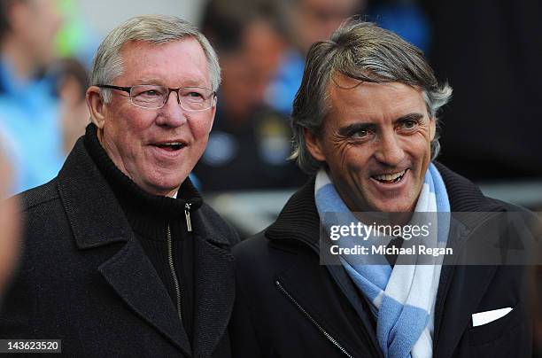 Manchester United manager Sir Alex Ferguson and Manchester City manager Roberto Mancini look on before the Barclays Premier League match between...