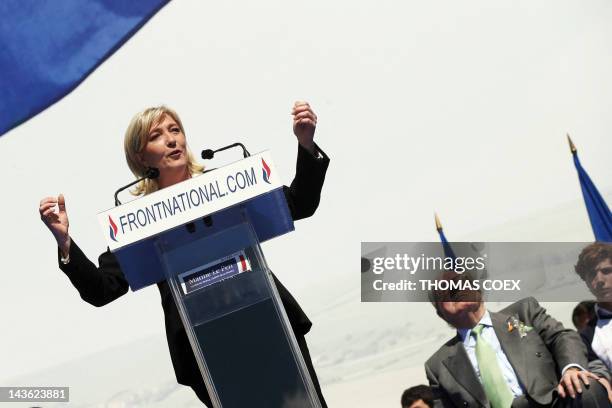 French far right party Front National candidate Marine Le Pen delivers a speech as his father FN honour president Jean-Marie Le Pen listens, on May...