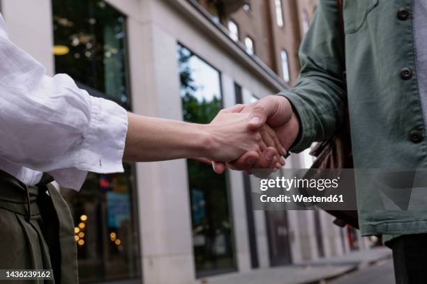 Front Handshake Handshake In Front Of Building Photos and Premium High Res Pictures ...