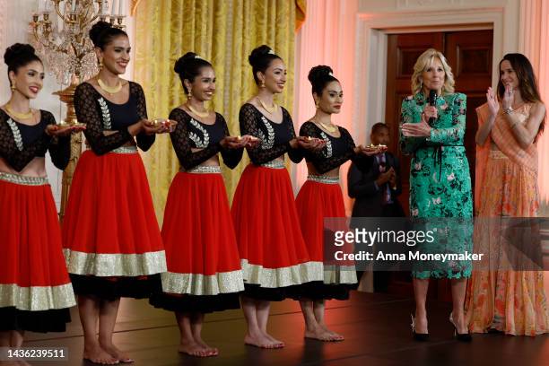 First Lady Jill Biden and her daughter Ashley Biden stand onstage with dancers from the Sa Dance Company perform during a reception celebrating the...