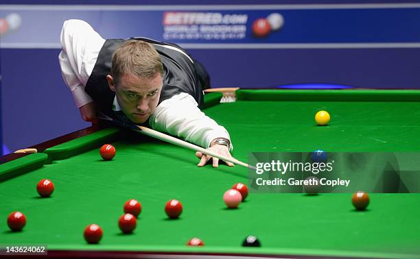 Stephen Hendry of Scotland plays a shot in his quarter final match against Stephen Maguire of Scotland during the Betfred.com World Snooker...