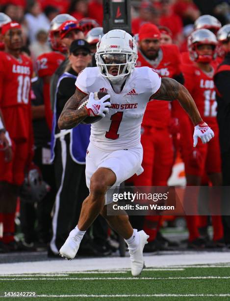 Wide receiver Nikko Remigio of the Fresno State Bulldogs runs for yardage after making a catch against safety Jer'Marius Lewis of the New Mexico...