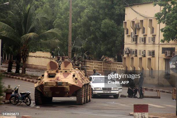 Soldiers loyal to Captain Amadou Haya Sanogo sit on an armoured vehicle at the Patrice Lumouda roundabout, 500m from Mali's radio station ORTM, in...
