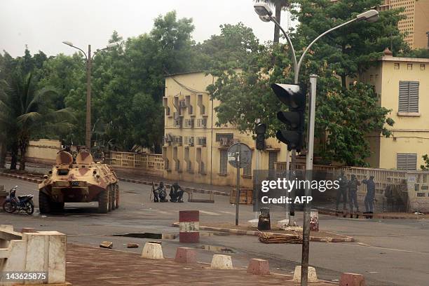 Soldiers loyal to Captain Amadou Haya Sanogo sit on an armoured vehicle and stand guard at the Patrice Lumouda roundabout, 500m from Mali's radio...