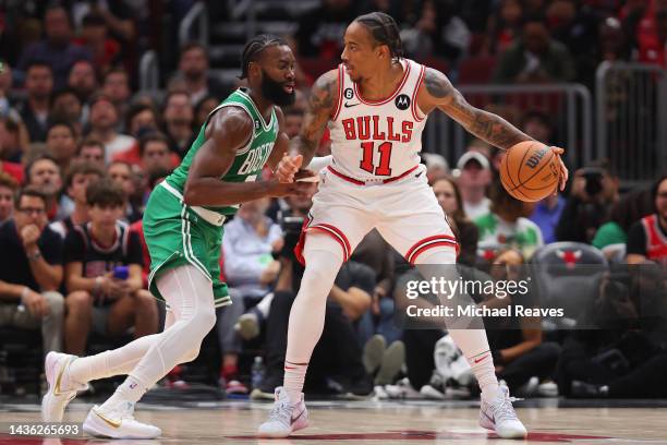 DeMar DeRozan of the Chicago Bulls dribbles against Jaylen Brown of the Boston Celtics during the first half at United Center on October 24, 2022 in...