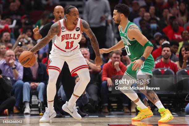 DeMar DeRozan of the Chicago Bulls dribbles Jayson Tatum of the Boston Celtics during the first half at United Center on October 24, 2022 in Chicago,...