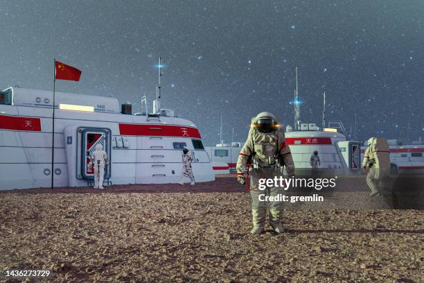 chinese astronauts working on exo planet surface - military base buildings stock pictures, royalty-free photos & images