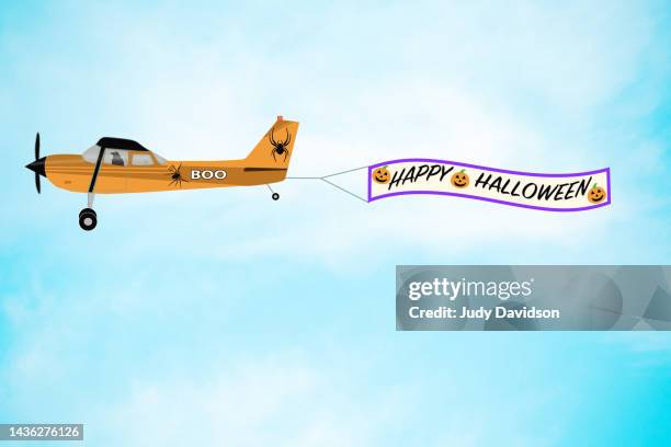 happy halloween banner towing airplane illustration - airplane banner stock pictures, royalty-free photos & images