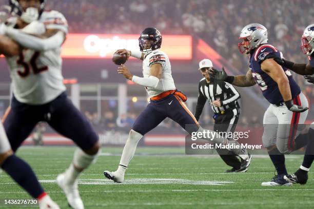 Justin Fields of the Chicago Bears looks to pass during the first half against the New England Patriots at Gillette Stadium on October 24, 2022 in...