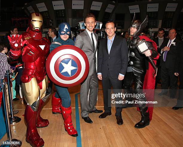 Actors Tom Hiddleston and Clark Gregg ring the opening bell at the New York Stock Exchange on May 1, 2012 in New York City.