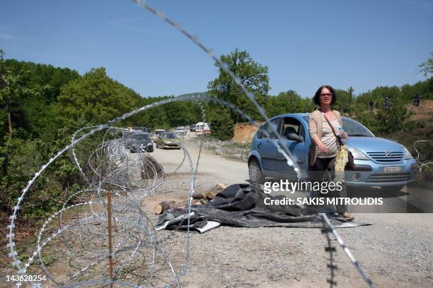 Woman passes by barbed wire next to the mining of Skouries on May 1, 2012. Local groups in Megali Panagia,Chalkidiki, northern Greece, protested...