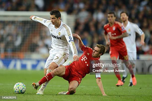 Philipp Lahm of Bayern Munich tackles Cristiano Ronaldo of Real Madrid during the UEFA Champions League Semi Final second leg between Real Madrid CF...