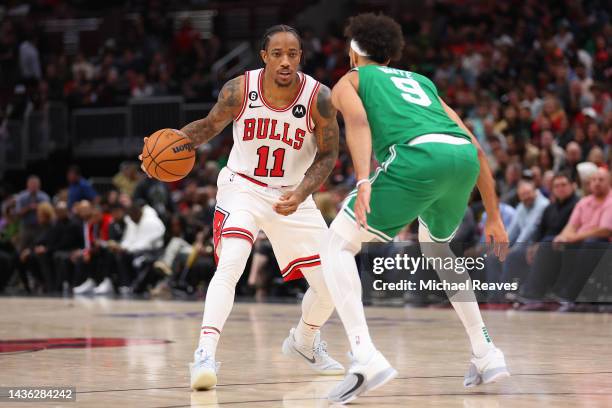 DeMar DeRozan of the Chicago Bulls dribbles against Derrick White of the Boston Celtics during the second half at United Center on October 24, 2022...