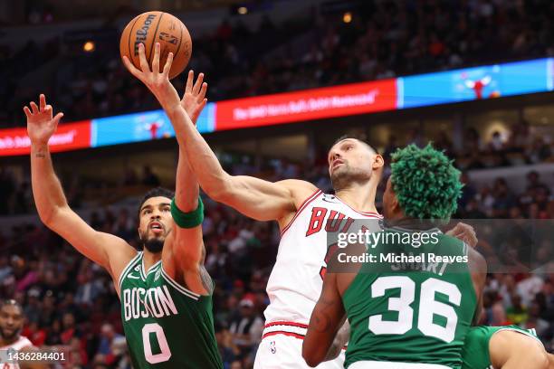 Jayson Tatum of the Boston Celtics and Nikola Vucevic of the Chicago Bulls battle for a rebound during the second half at United Center on October...