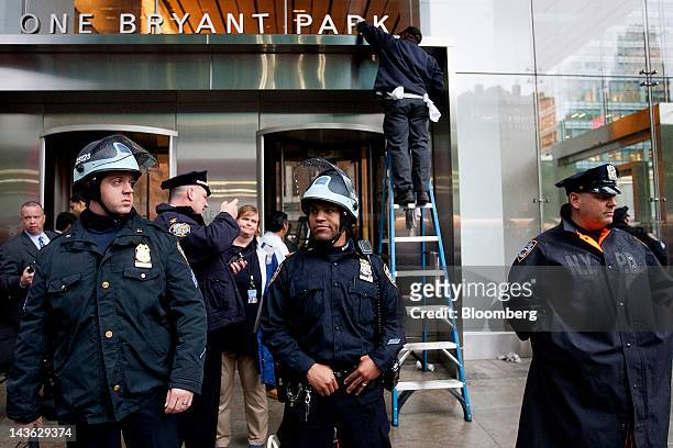 New York Police Department officers stand watch in front of the Bank of America Corp. Tower in New York, U.S., on Tuesday, May 1, 2012. Occupy Wall...