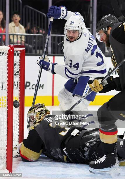 Logan Thompson of the Vegas Golden Knights makes a save against Auston Matthews of the Toronto Maple Leafs as Alex Pietrangelo of the Golden Knights...