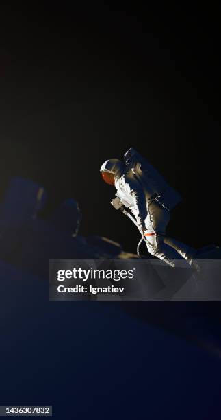 astronaut in an outer space on a bblack background for a space concept designs - astronaut space suit stock pictures, royalty-free photos & images