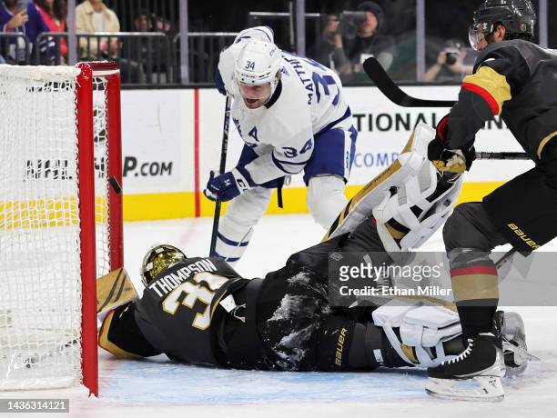 Logan Thompson of the Vegas Golden Knights makes a save against Auston Matthews of the Toronto Maple Leafs in the first period of their game at...