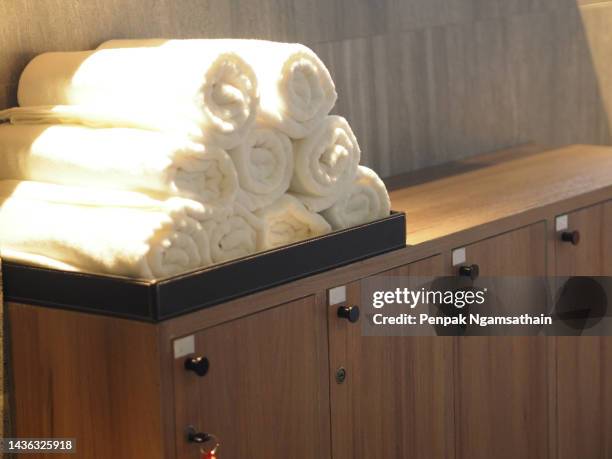 towels are placed on the wooden cabinet - shower shelf stock pictures, royalty-free photos & images