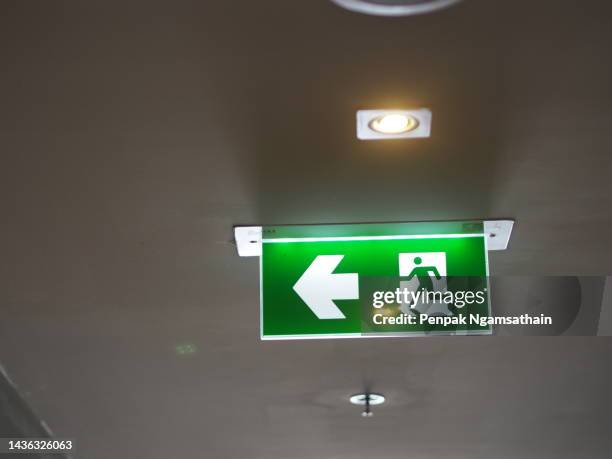 fire exit sign - workplace evacuation stock pictures, royalty-free photos & images