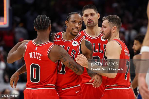 DeMar DeRozan of the Chicago Bulls is consoled by teammates after missing the potential game winning three point basket with two seconds left in the...