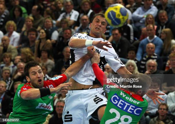 Momir Ilic of Kiel challens Bennet Wiegert and Robert Weber of Magdeburg during the Toyota Handball Bundesliga match between THW Kiel and SC...