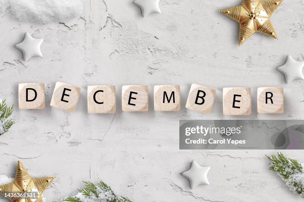 flat lay december message in wooden blocks calendar with christmas ornaments - season schedule announcement stock pictures, royalty-free photos & images